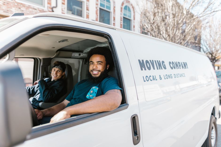 Friendly moving team discussing logistics with a homeowner