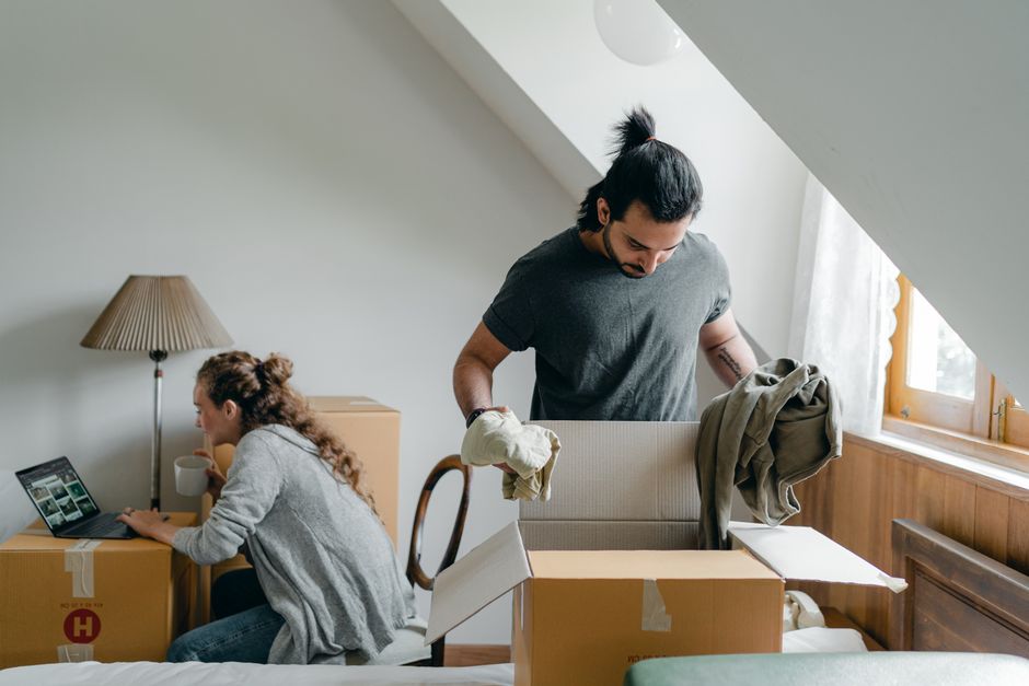 Family happily unpacking boxes in their new home